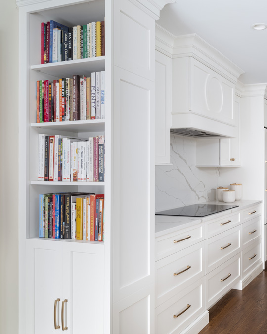 Custom shelving for cookbooks in white kitchen by Glenna Stone Interior Design