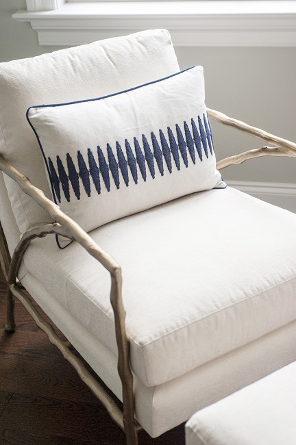 Blue and white patterned throw pillow on reading chair in Main Line great room by Glenna Stone Interior Design