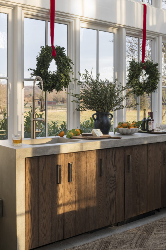 Holiday greenery on a custom home bar at a New Hope farmhouse designed by Glenna Stone Interiors.